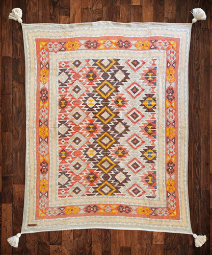 Decorative rug with geometric pattern on a wooden floor